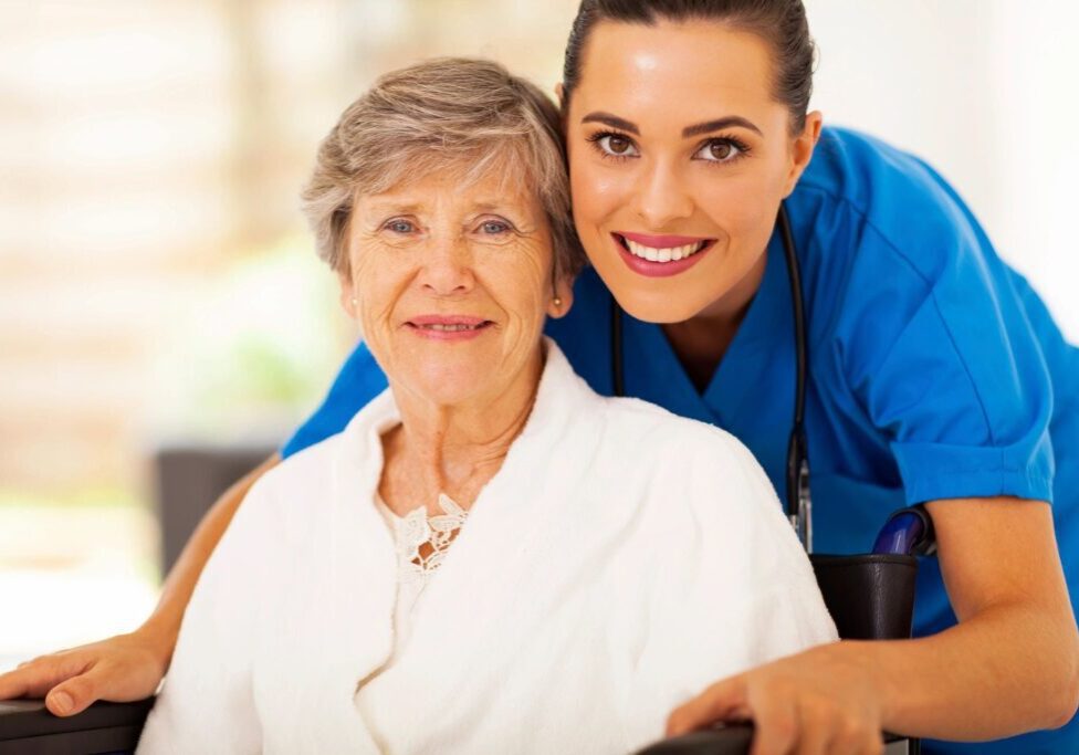 A woman and an older person smiling for the camera.